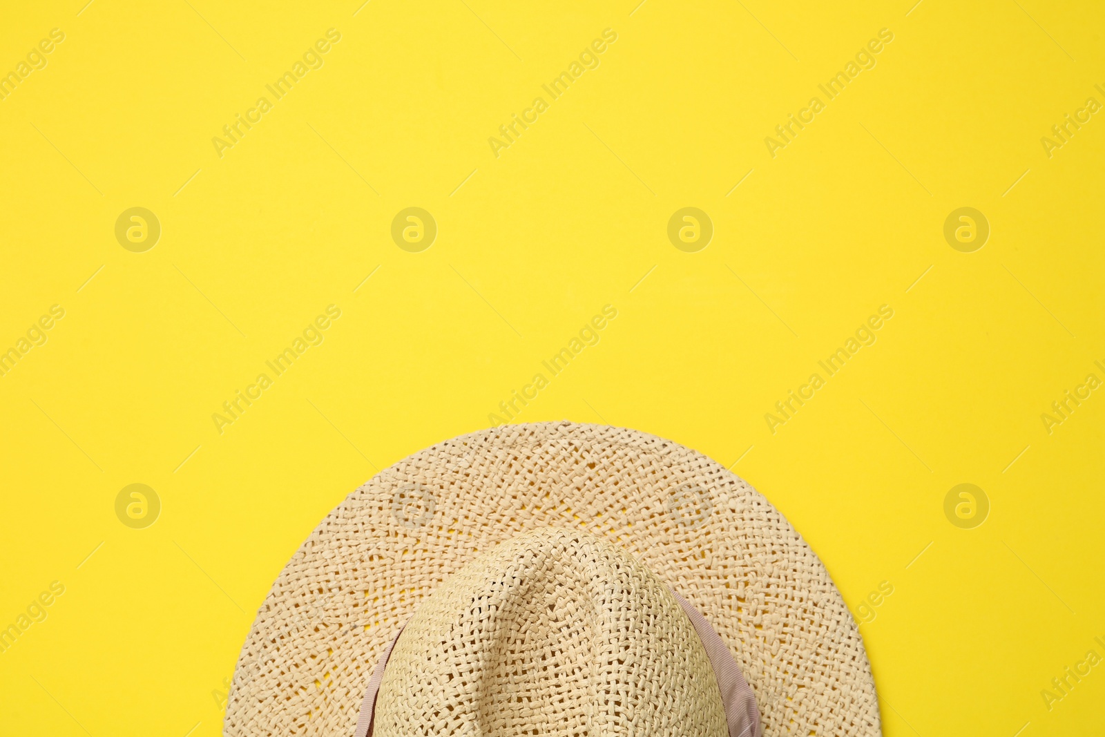 Photo of Hat on yellow background, top view with space for text. Sun protection