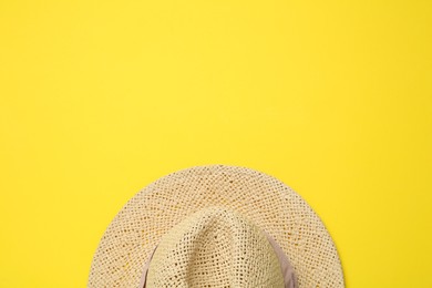 Hat on yellow background, top view with space for text. Sun protection