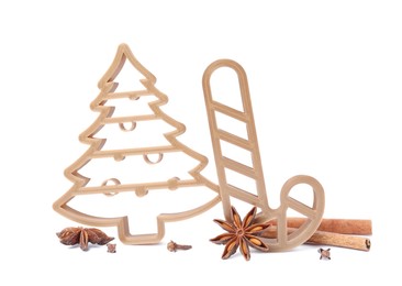 Photo of Cookie cutters in shape of Christmas tree and candy cane on white background