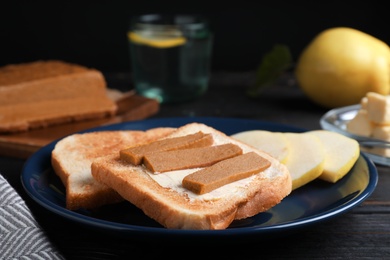 Tasty sandwich with quince paste served for breakfast on dark table, closeup