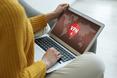 Image of Woman using laptop with switched on VPN indoors, closeup