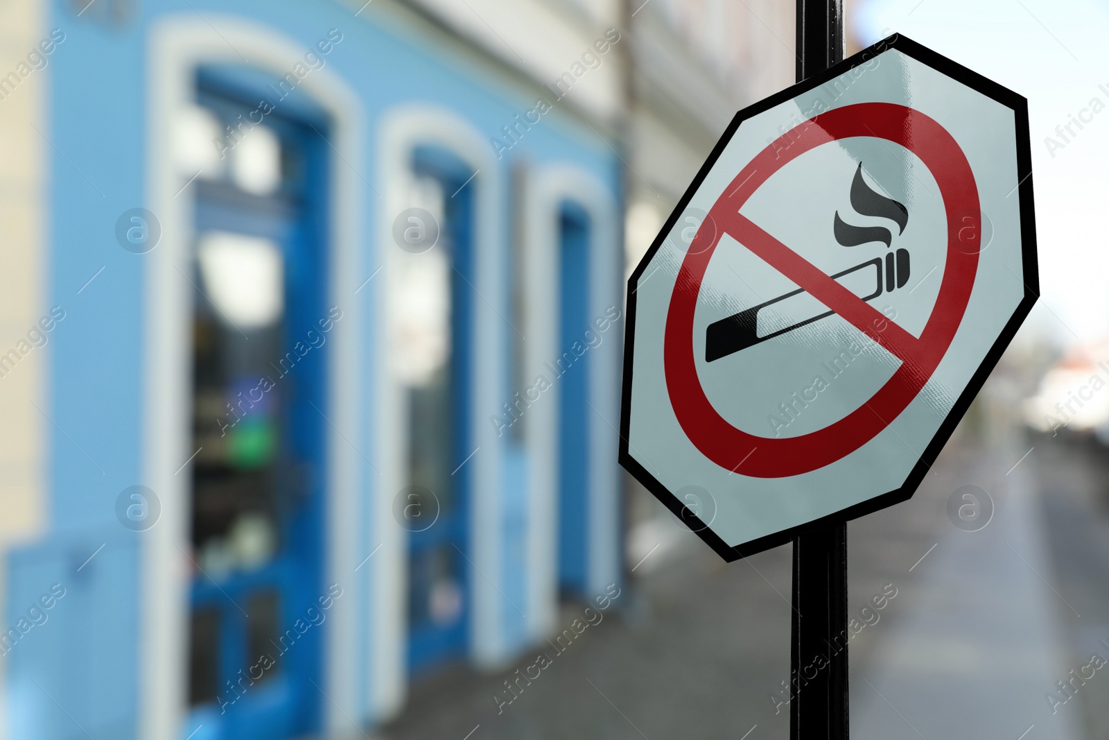 Image of Sign No Smoking on city street. Space for text