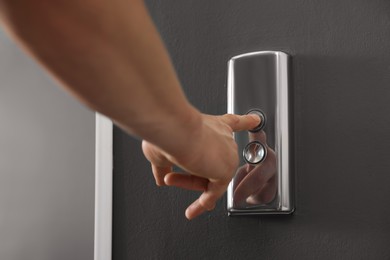 Man pressing elevator call button, closeup view