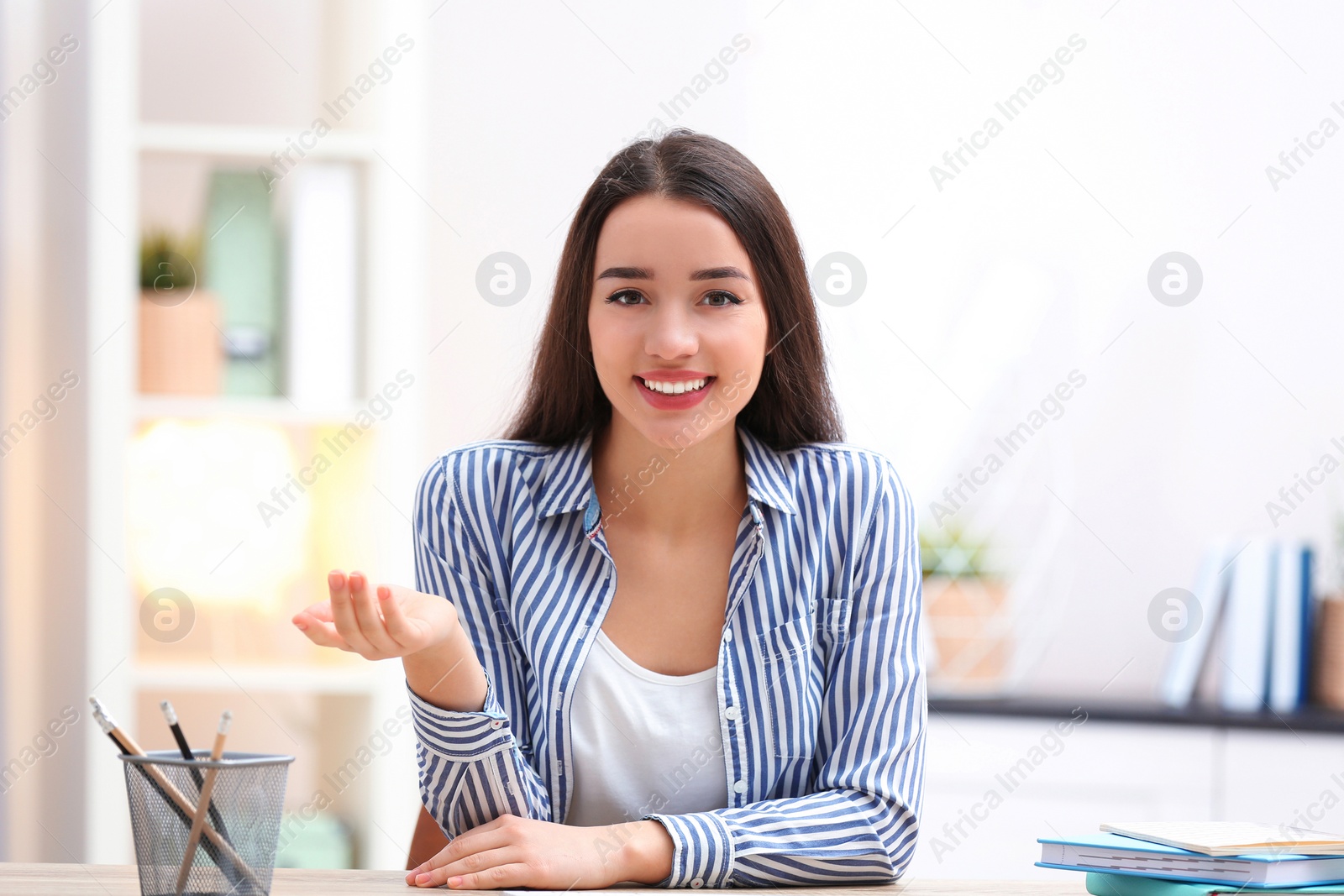 Photo of Beautiful woman using video chat for conversation indoors