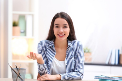 Photo of Beautiful woman using video chat for conversation indoors