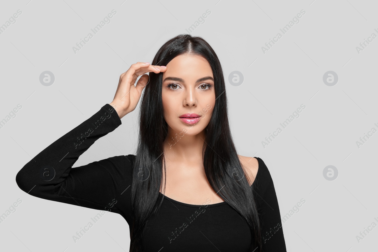 Photo of Portrait of beautiful young woman on light grey background