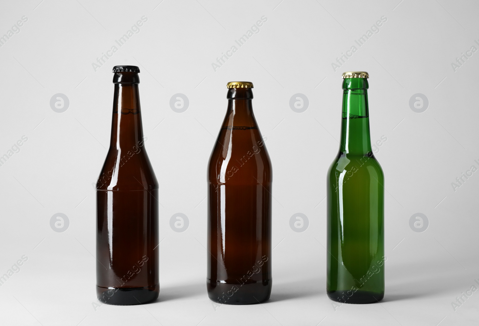 Photo of Bottle with different types of beer on light background