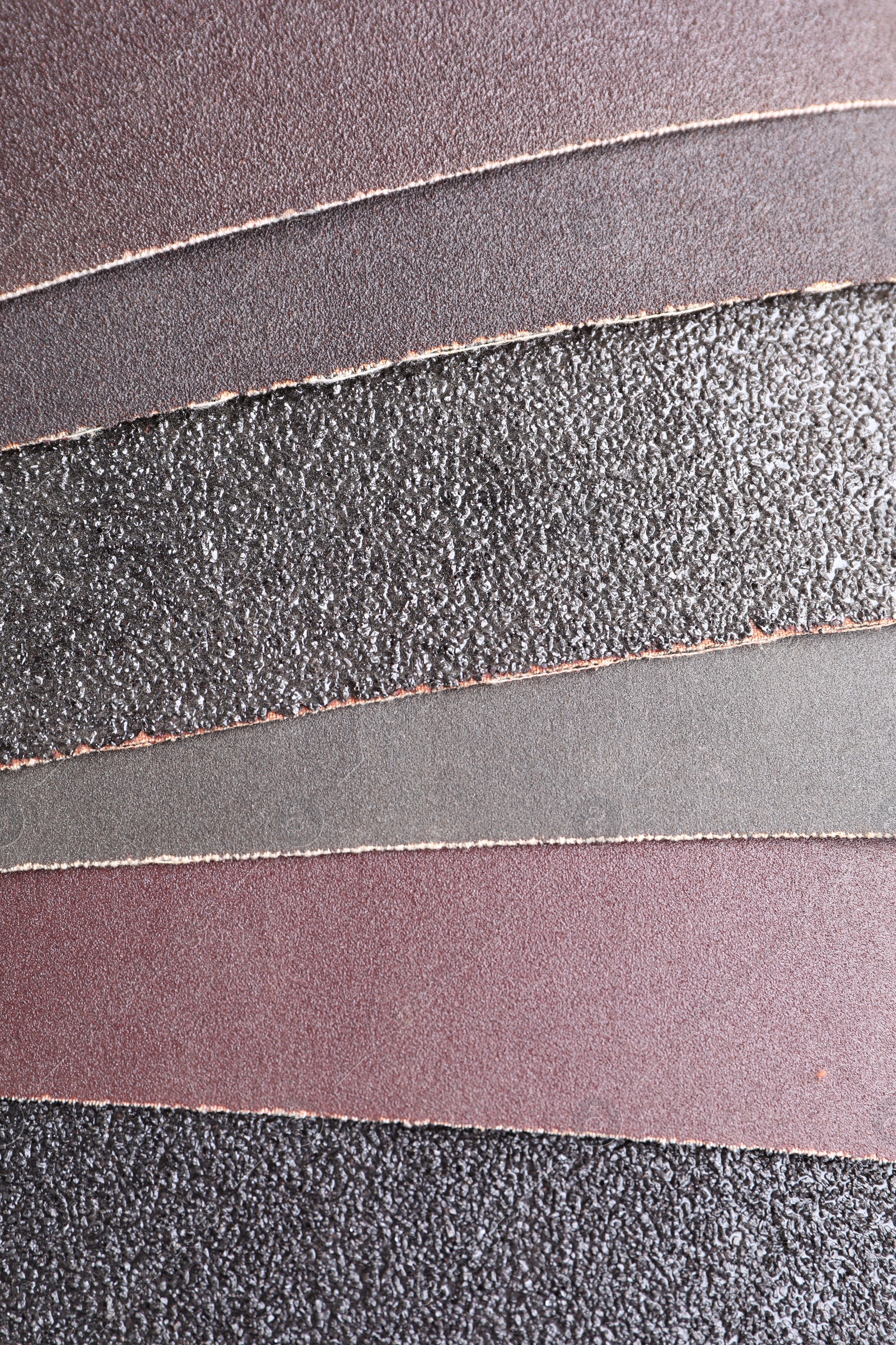 Photo of Many sheets of sandpaper as background, top view