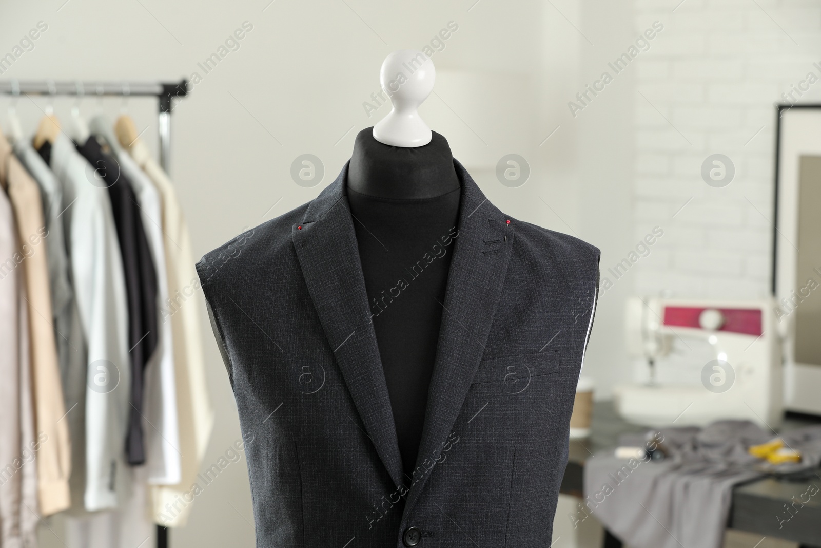 Photo of Mannequin with unfinished jacket in tailor shop