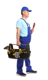 Photo of Mature plumber with pipe wrench and tool bag on white background