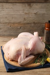 Fresh raw chicken with spices on wooden table