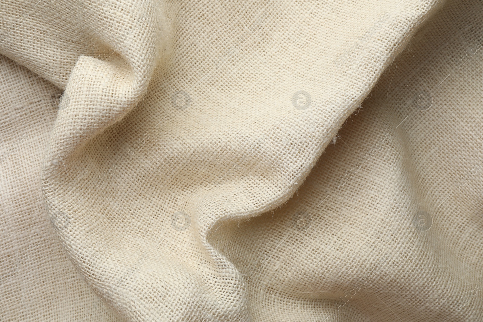 Photo of Texture of beige crumpled fabric as background, top view