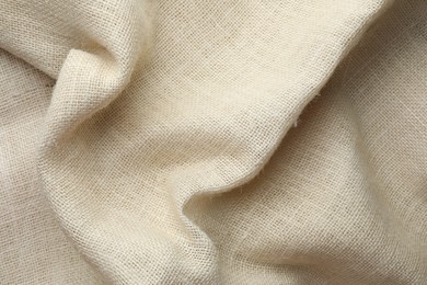 Texture of beige crumpled fabric as background, top view