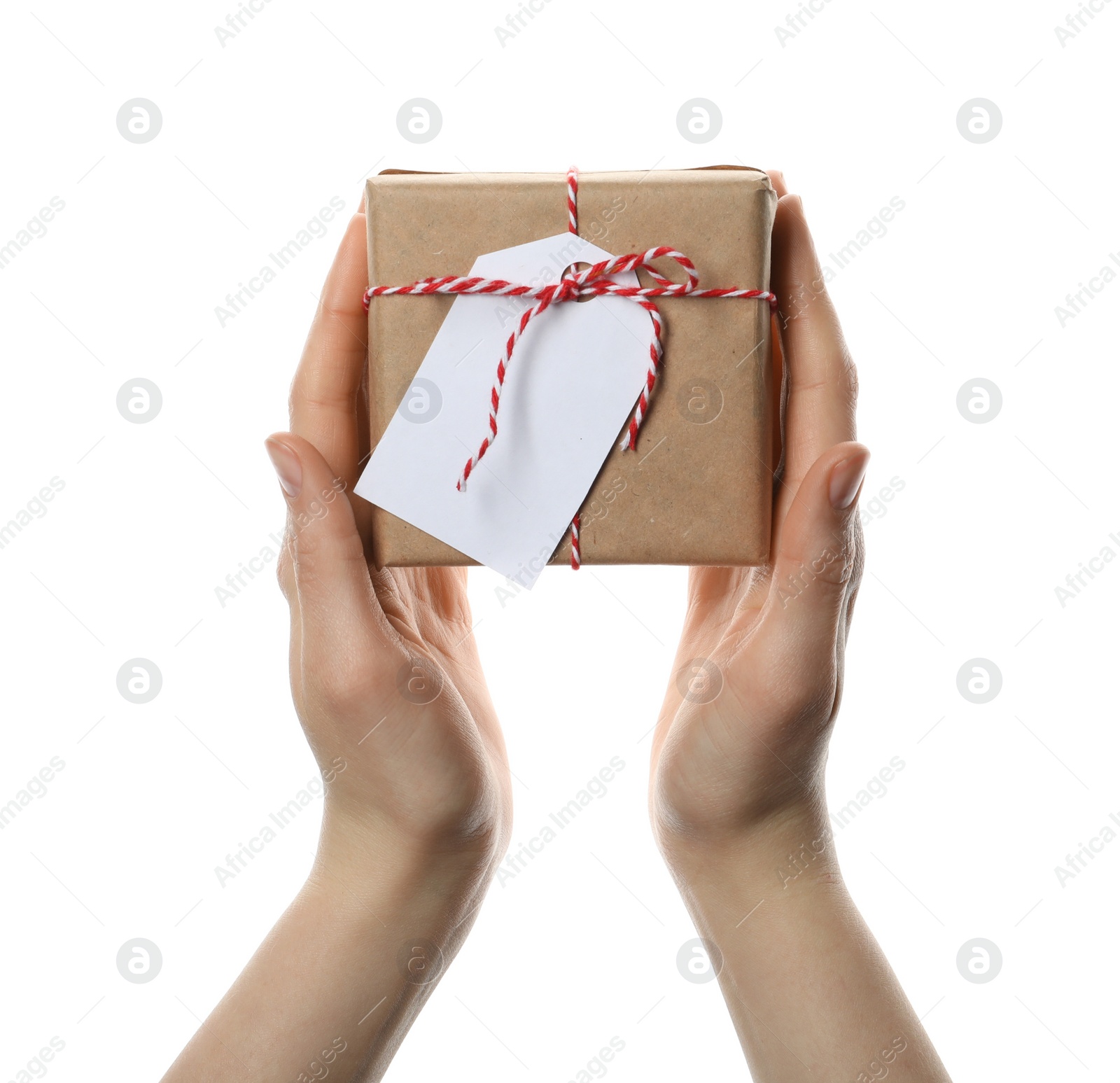 Photo of Woman holding parcel wrapped in kraft paper with tag on white background, closeup