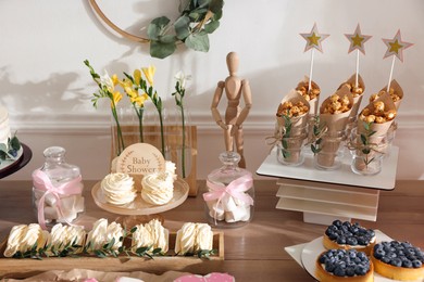 Delicious party treats on wooden table indoors