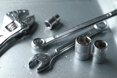 Auto mechanic's tools on metallic surface, closeup
