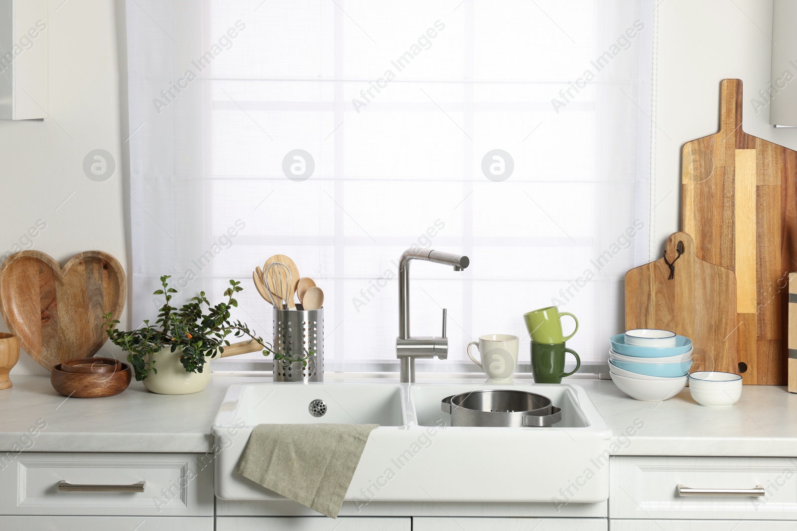 Photo of Countertop with sink and cooking utensils in kitchen