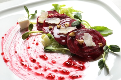 Photo of Delicious salad with beet on plate, closeup