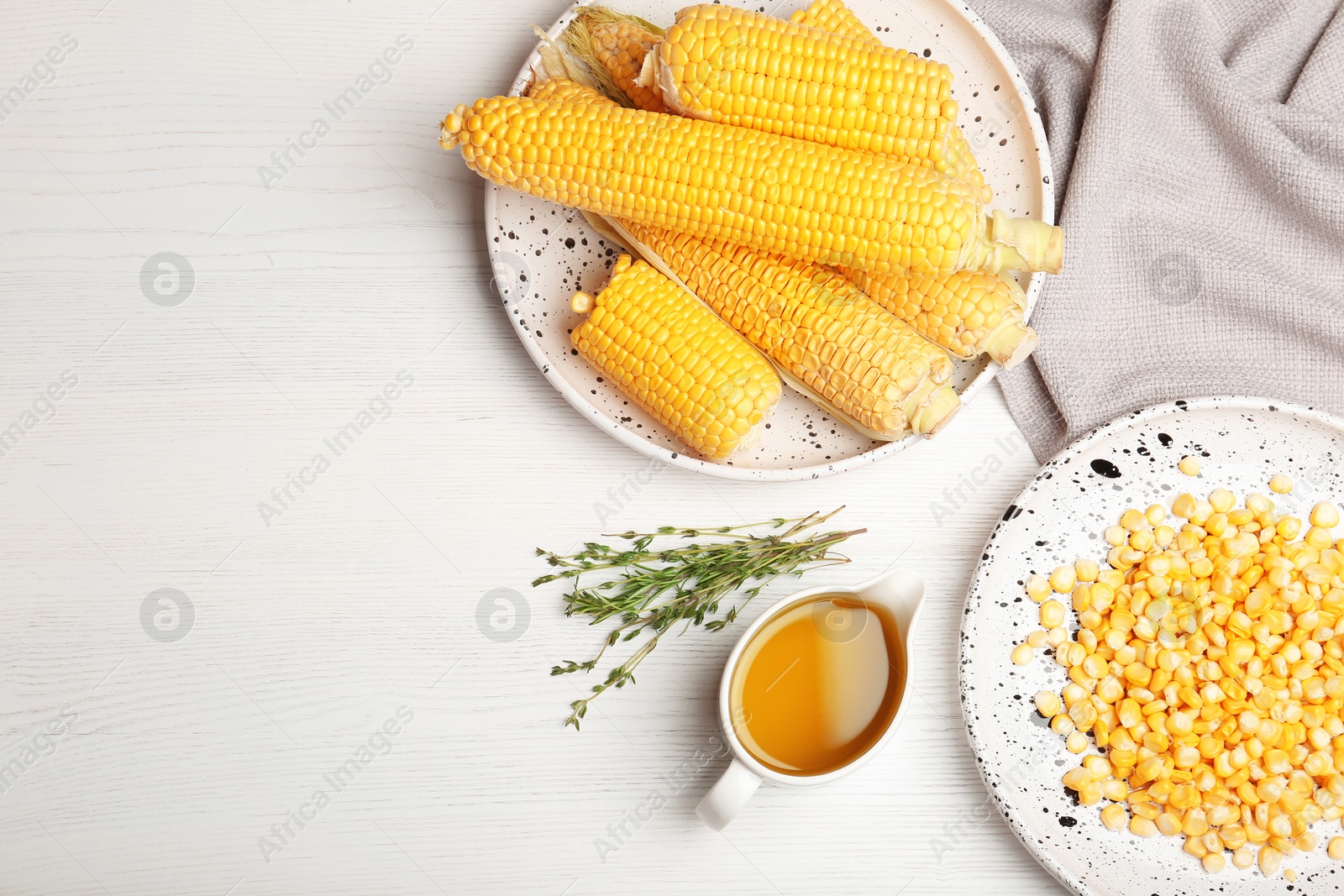 Photo of Flat lay composition with fresh corn oil on wooden table