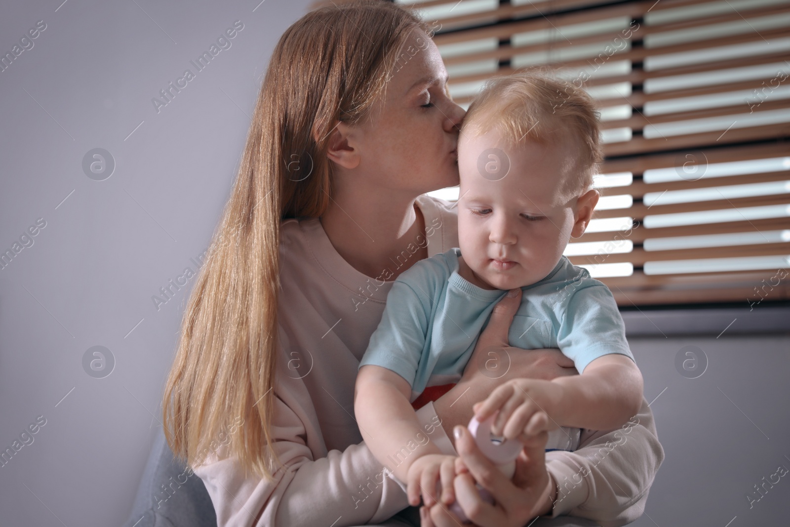 Photo of Young single mother with her child at home