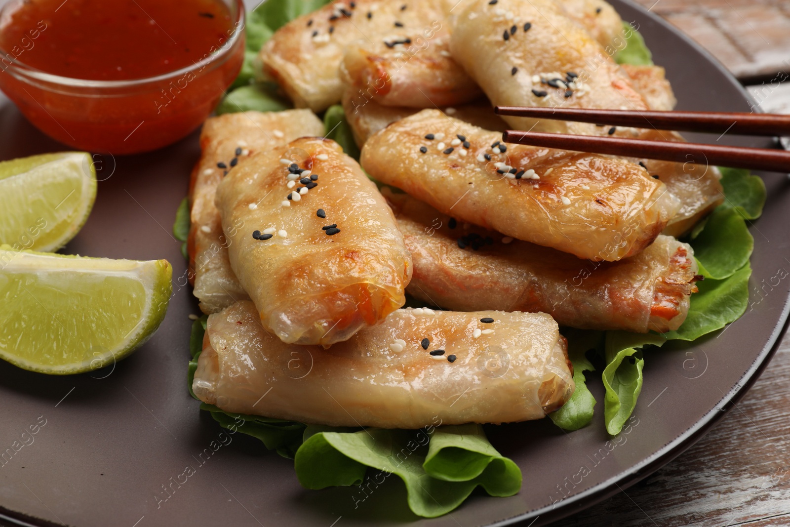 Photo of Tasty fried spring rolls served on table, closeup