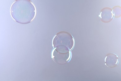 Photo of Beautiful transparent soap bubbles on gray background