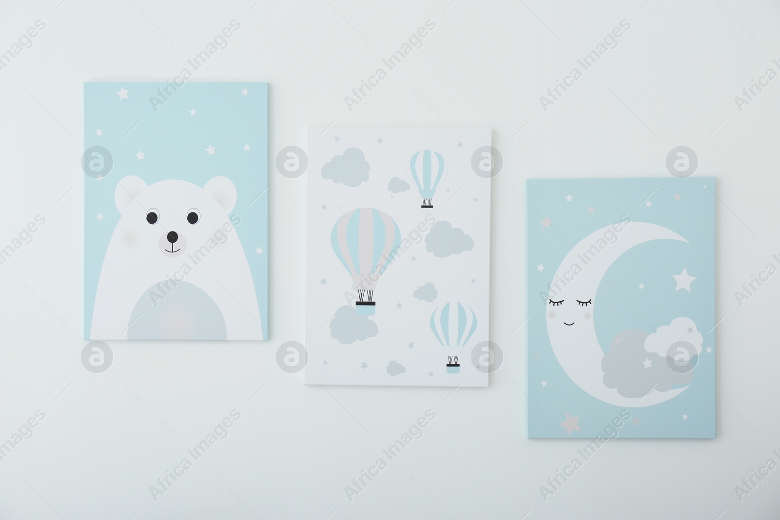 Photo of Different cute pictures on white wall. Children's room interior elements