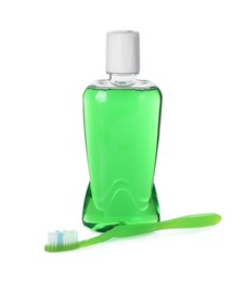 Photo of Bottle of mouthwash and toothbrush isolated on white