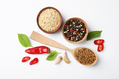 Composition with different aromatic spices on white background, top view