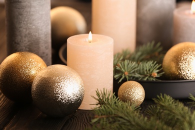 Burning candles with Christmas decoration on table, closeup