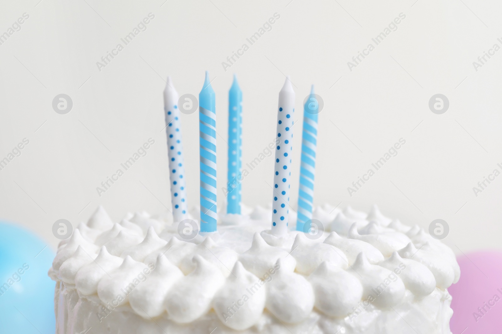 Photo of Delicious cake with cream and candles on white background, closeup