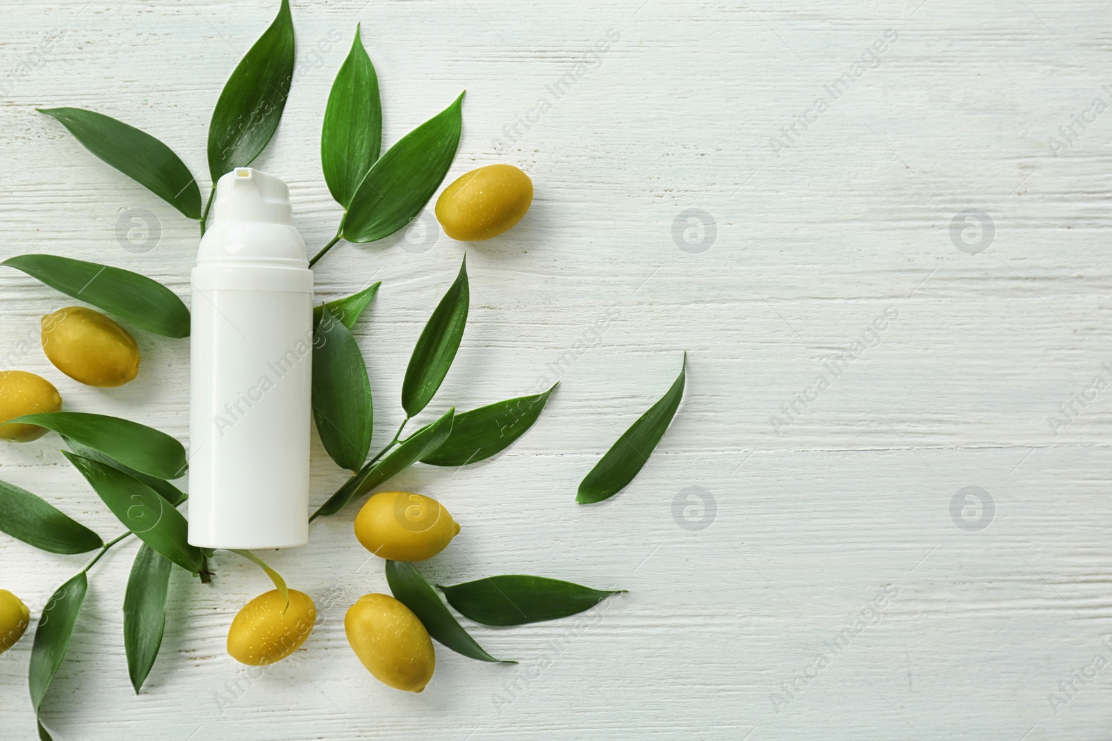 Photo of Beautiful composition with bottle of cream on wooden background, flat lay