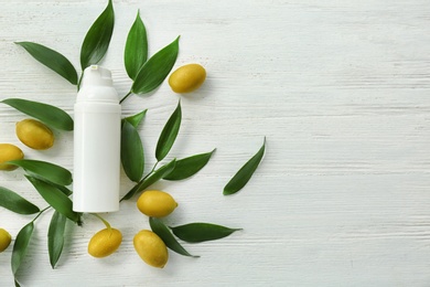 Photo of Beautiful composition with bottle of cream on wooden background, flat lay