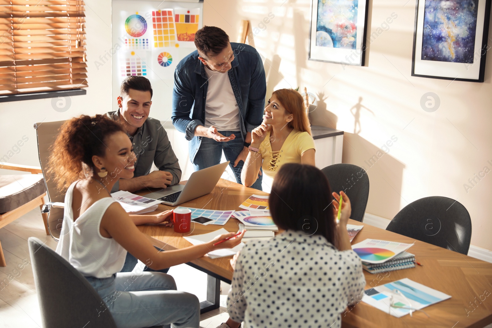 Photo of Team of professional designers working in office