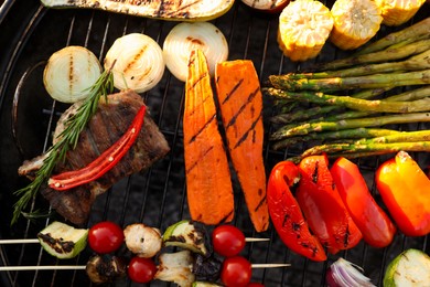 Photo of Delicious grilled vegetables on barbecue grill outdoors, top view