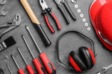 Photo of Flat lay composition with different construction tools on grey background