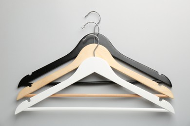 Photo of Different hangers on light gray background, top view