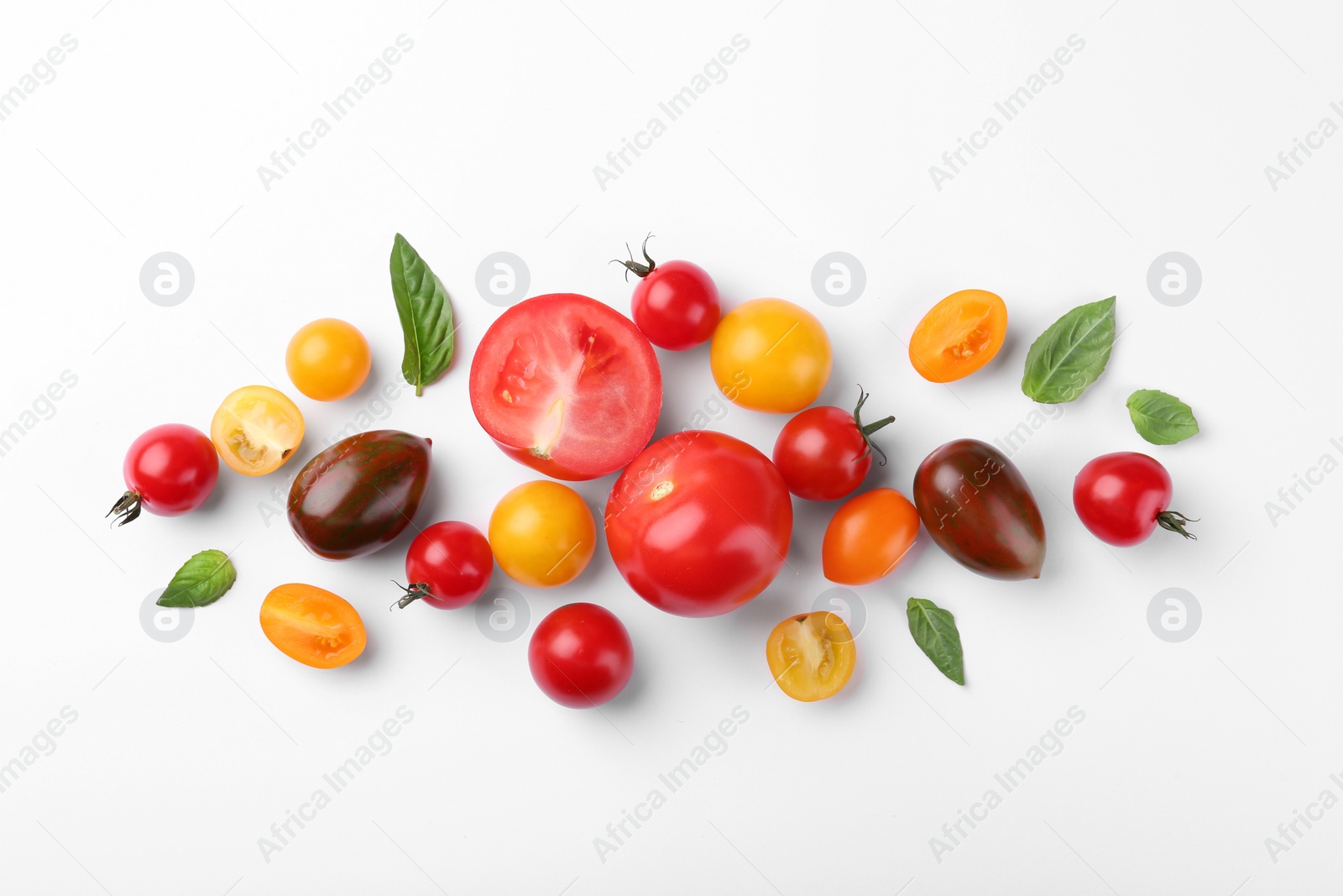 Photo of Flat lay composition with different whole and cut tomatoes on white background