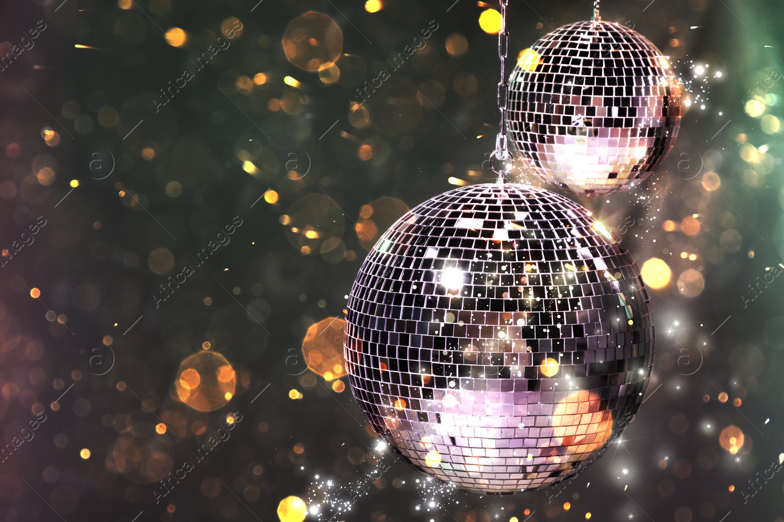 Image of Shiny disco balls on dark background with blurred lights, space for text. Bokeh effect