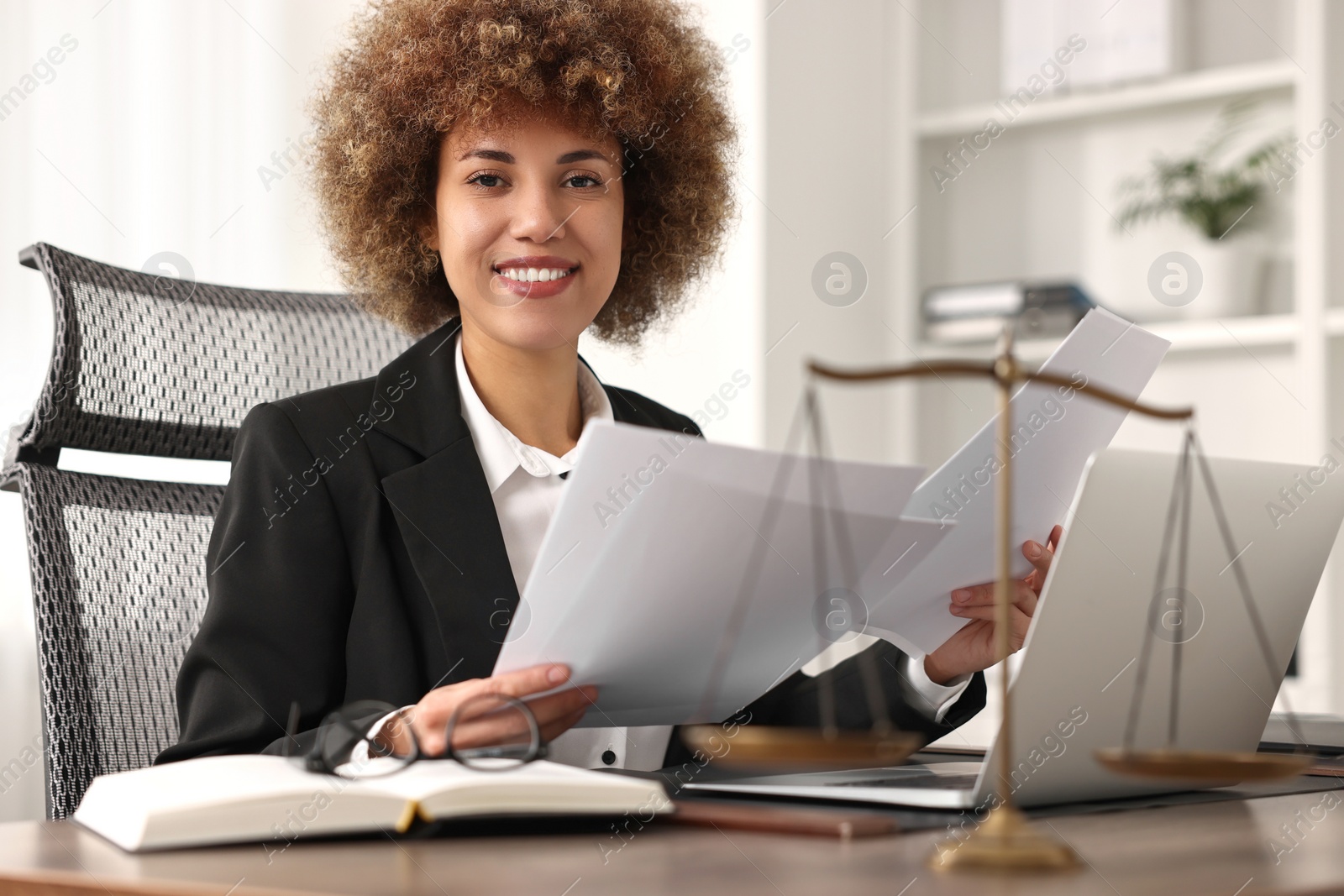 Photo of Notary working with documents at workplace in office