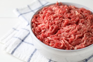 Raw ground meat in bowl on table, closeup