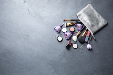 Photo of Many different makeup products and spring flowers on color background, flat lay. Space for text