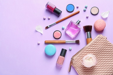 Photo of Makeup products with cosmetic bag on color background