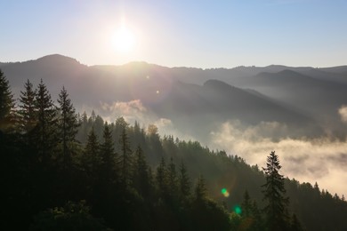 Photo of Picturesque view of fog in mountains on sunny day