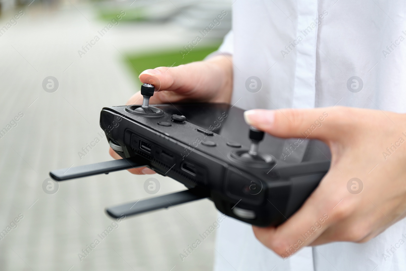 Photo of Woman with modern drone controller outdoors, closeup