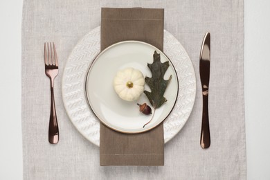 Photo of Autumn table setting, pumpkin and dry leaf, flat lay