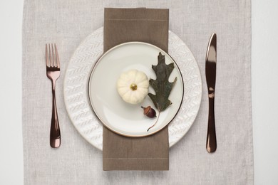 Autumn table setting, pumpkin and dry leaf, flat lay