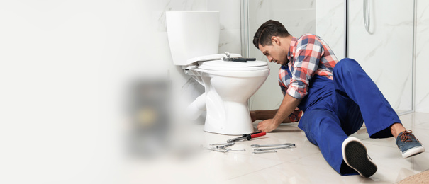 Image of Professional plumber working with toilet bowl in bathroom, space for text. Banner design