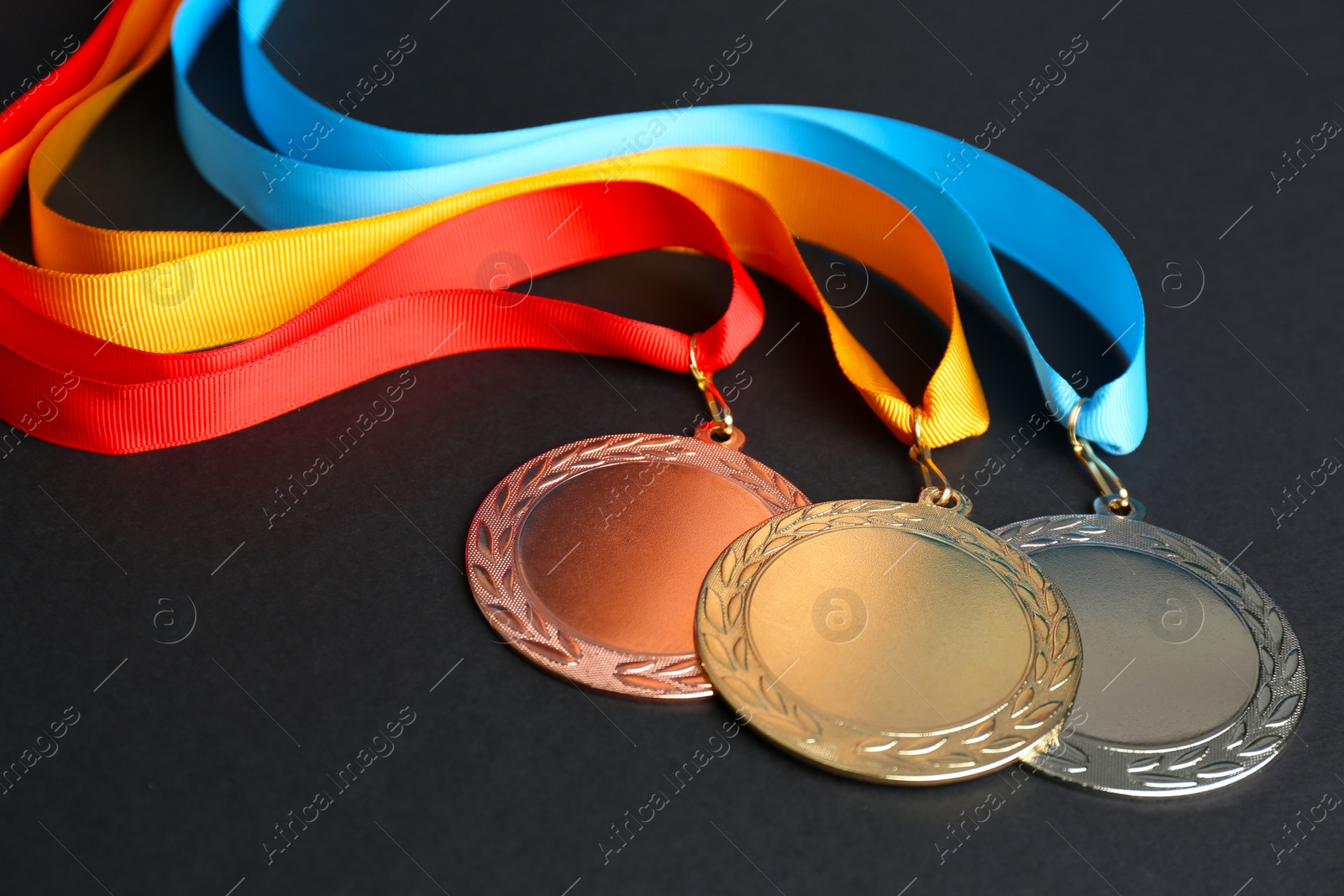 Photo of Gold, silver and bronze medals on black background. Space for design