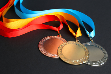 Gold, silver and bronze medals on black background. Space for design